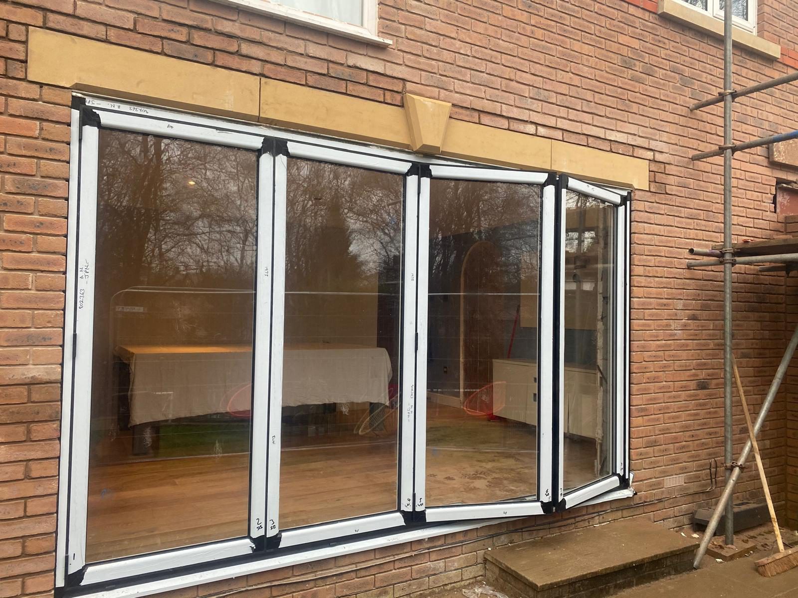 Newly installed aluminium bifold doors with protective film still attached