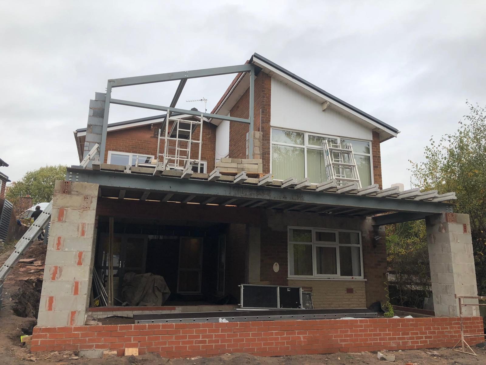 Steel structural frame under construction for a cantilevered balcony extension